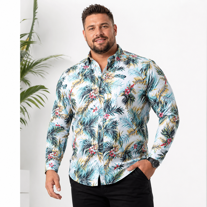 Male model wearing a light blue tropical floral long sleeve shirt, styled for a clean commercial studio product presentation.