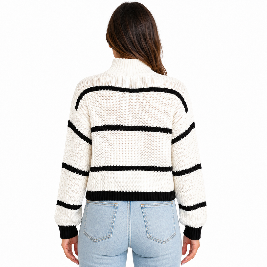 White striped mock-neck sweater shown from the back on a model with visible black stripes, ribbed cuffs, hem, and knit texture.
