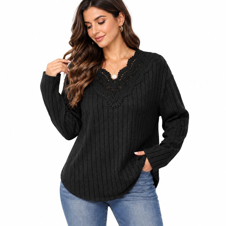 Black sweater sleeve, ribbing and curved hem detail