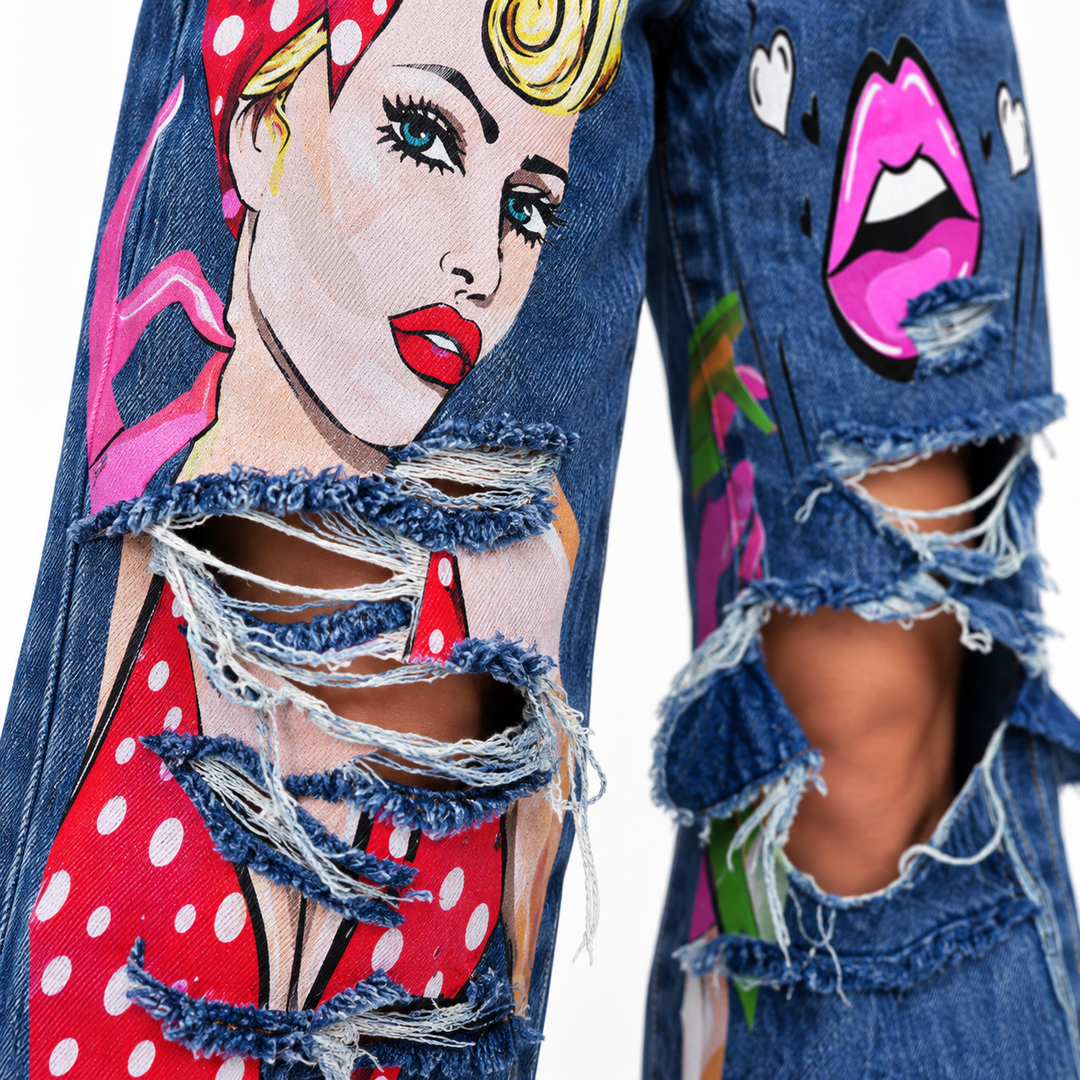 Close-up of black gray jeans showing waistband, belt loops, front pockets, button closure and graphic print details.