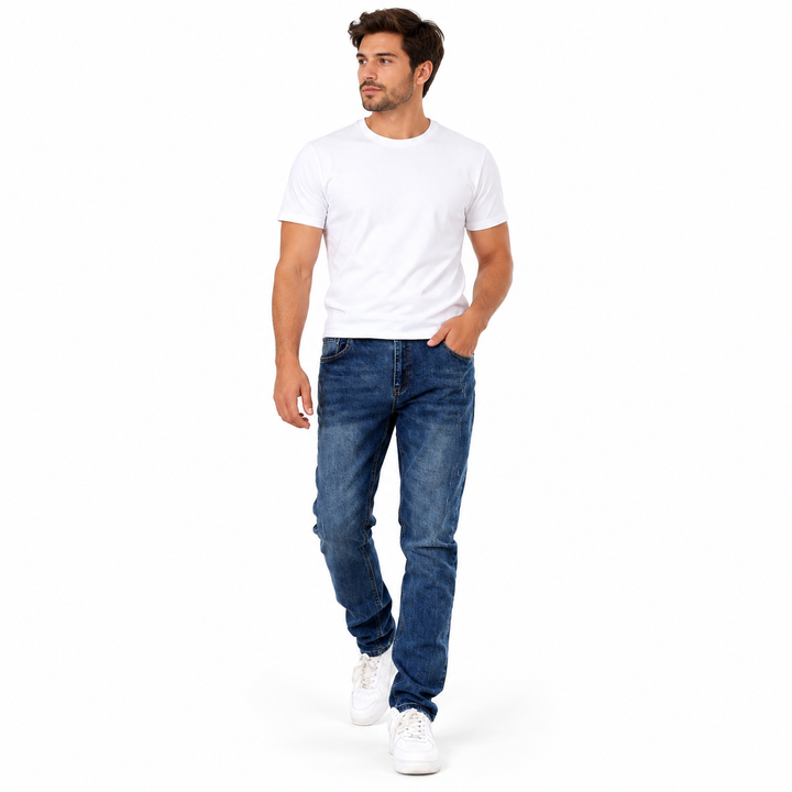 Blue washed jeans styled with a white shirt and sneakers on a walking model