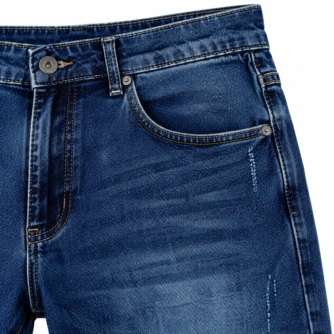 Close-up of blue denim wash and stitching around the front pocket
