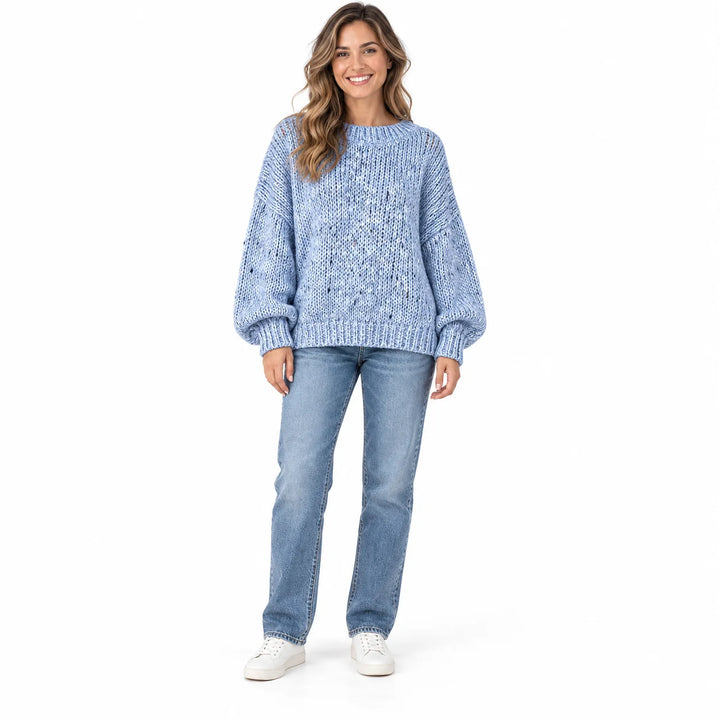 Powder Blue polka dot sweater on a full-length female model, with a ribbed neckline, relaxed sleeves and ribbed hem on white.
