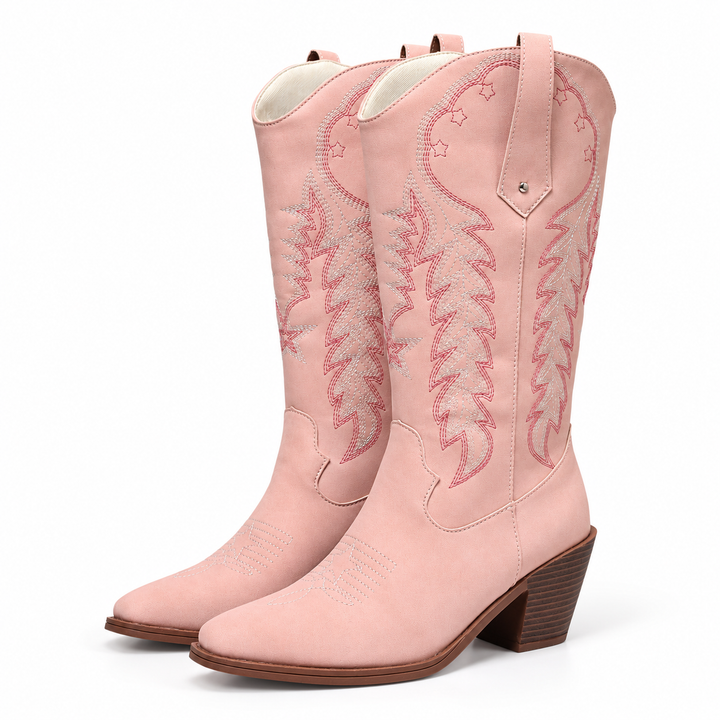 Three-quarter view of pink embroidered western boots with embroidery, pull tabs and chunky brown heels on a white background.