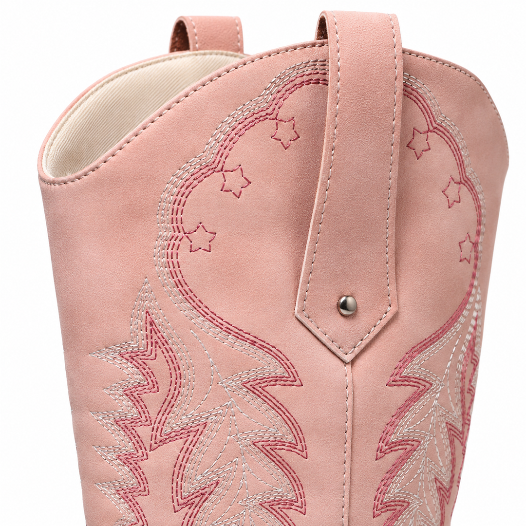 Close-up of the pink western boot shaft showing the pull tab, embroidery and original seam details in a white studio setting.