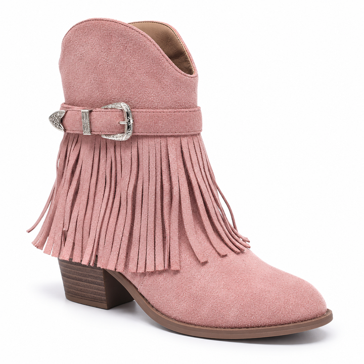 Three-quarter front view of a pink fringe ankle boot with buckle detail, fringe and a rounded toe against a white background.