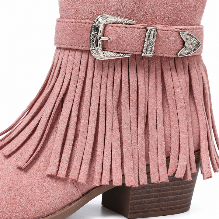 Close-up of a silver buckle on the pink boot with fringe strips and stitching visible around the strap on a white background.