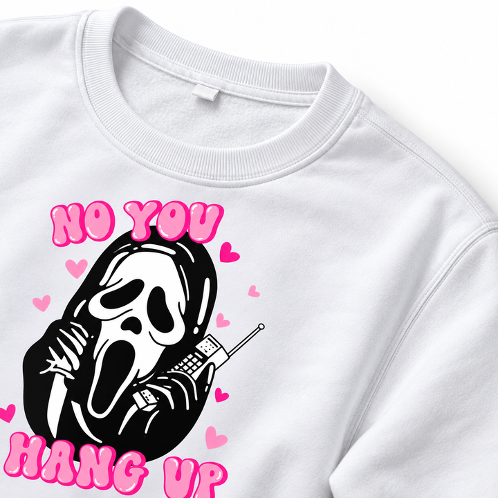 Detail view of the white sweatshirt neckline with stitching, pink lettering and part of the mask print on a white background.