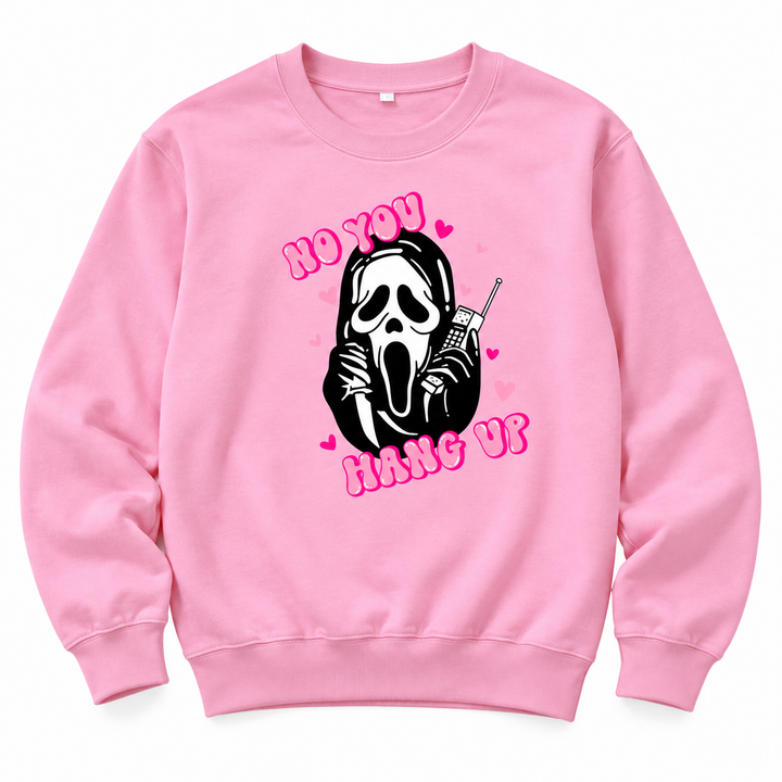 Studio view of a pink graphic sweatshirt with a mask and phone print, pink words and long sleeves against a white background.