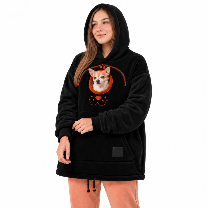 Three-quarter view of a black hooded pullover with an orange chest zipper, dog and a front pocket against a white background.