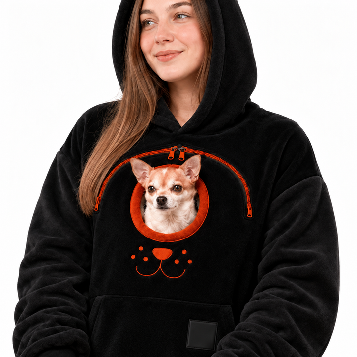 Close view of a black hooded pullover with a real small dog, front pocket and hem drawstrings against a plain white backdrop.