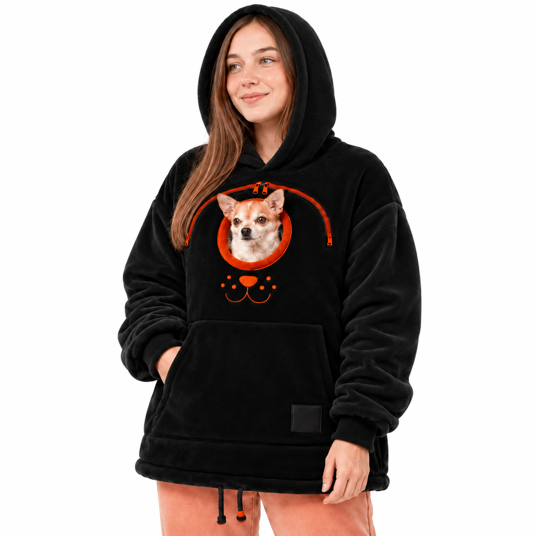 Close view of the black hooded pullover with hood edge, orange zipper, real dog and front pocket on a clean white background.