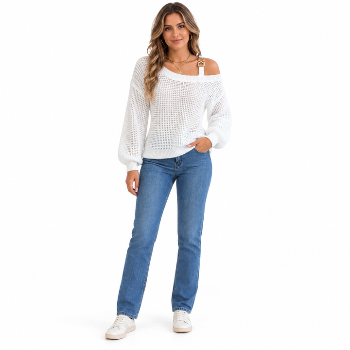 White off shoulder sweater with a metal buckle strap and lantern sleeves, worn by a woman with blue jeans on a white backdrop