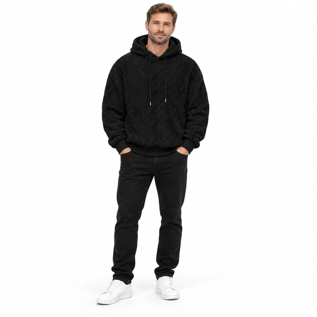Black jacquard hoodie shown on a second male model from head to toe, with tonal drawstrings, rib cuffs and a diamond pattern.