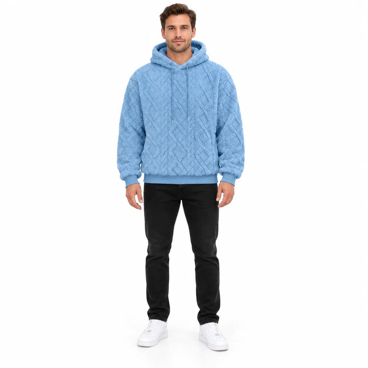 Sky blue hooded pullover shown from the front on a full-length male model, displaying geometric texture, rib cuffs and cords.