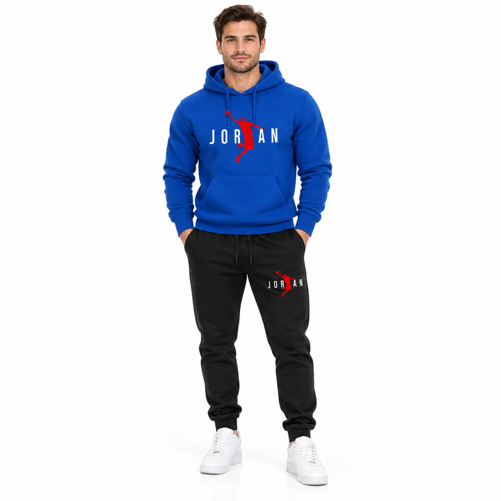 Male model wearing the royal blue / white lettering hoodie and black pants set on a white studio background.