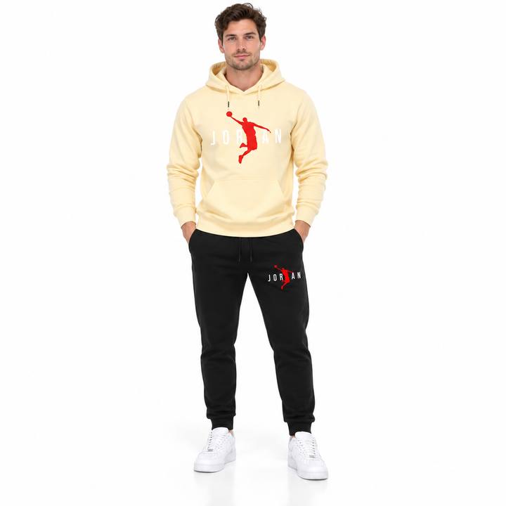 Male model wearing the cream / white lettering hoodie and black pants set on a white studio background.