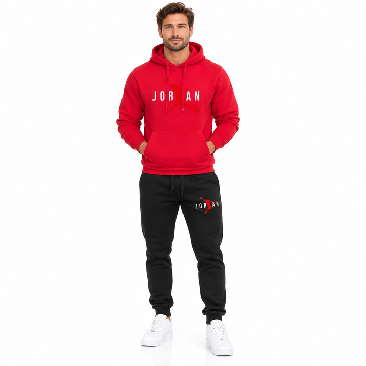 Male model wearing the red / white lettering hoodie and black pants set on a white studio background.