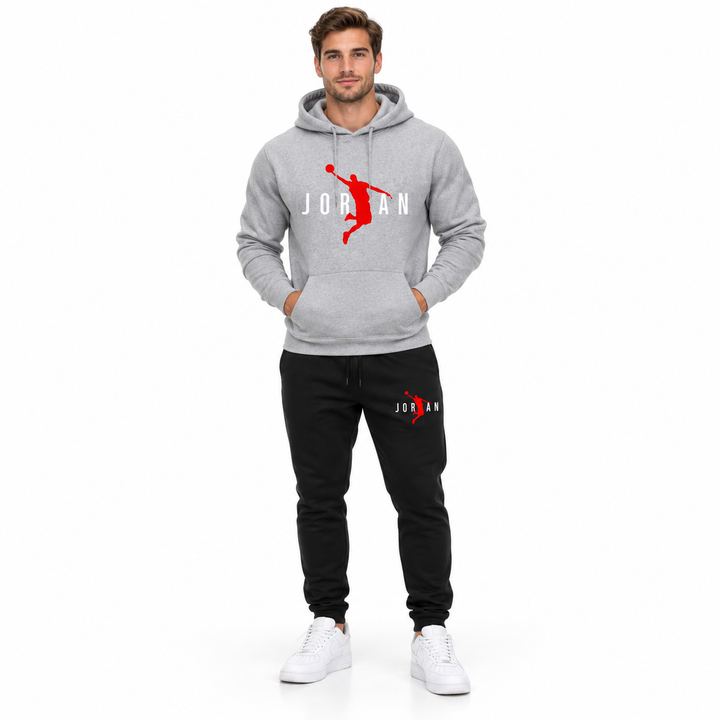 Male model wearing the light grey / white lettering hoodie and black pants set on a white studio background.
