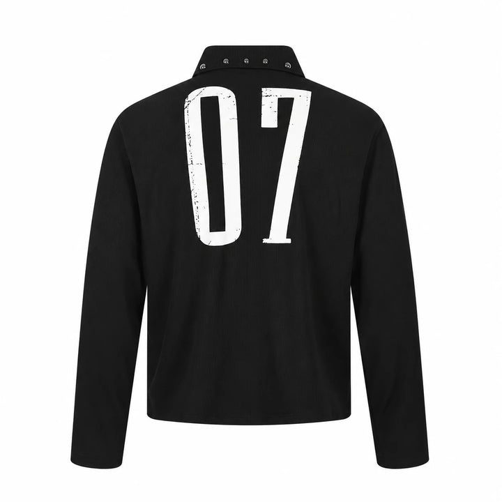 Back view of this black long sleeve unisex polo with a large distressed white 07 print, silver collar studs and straight hem.
