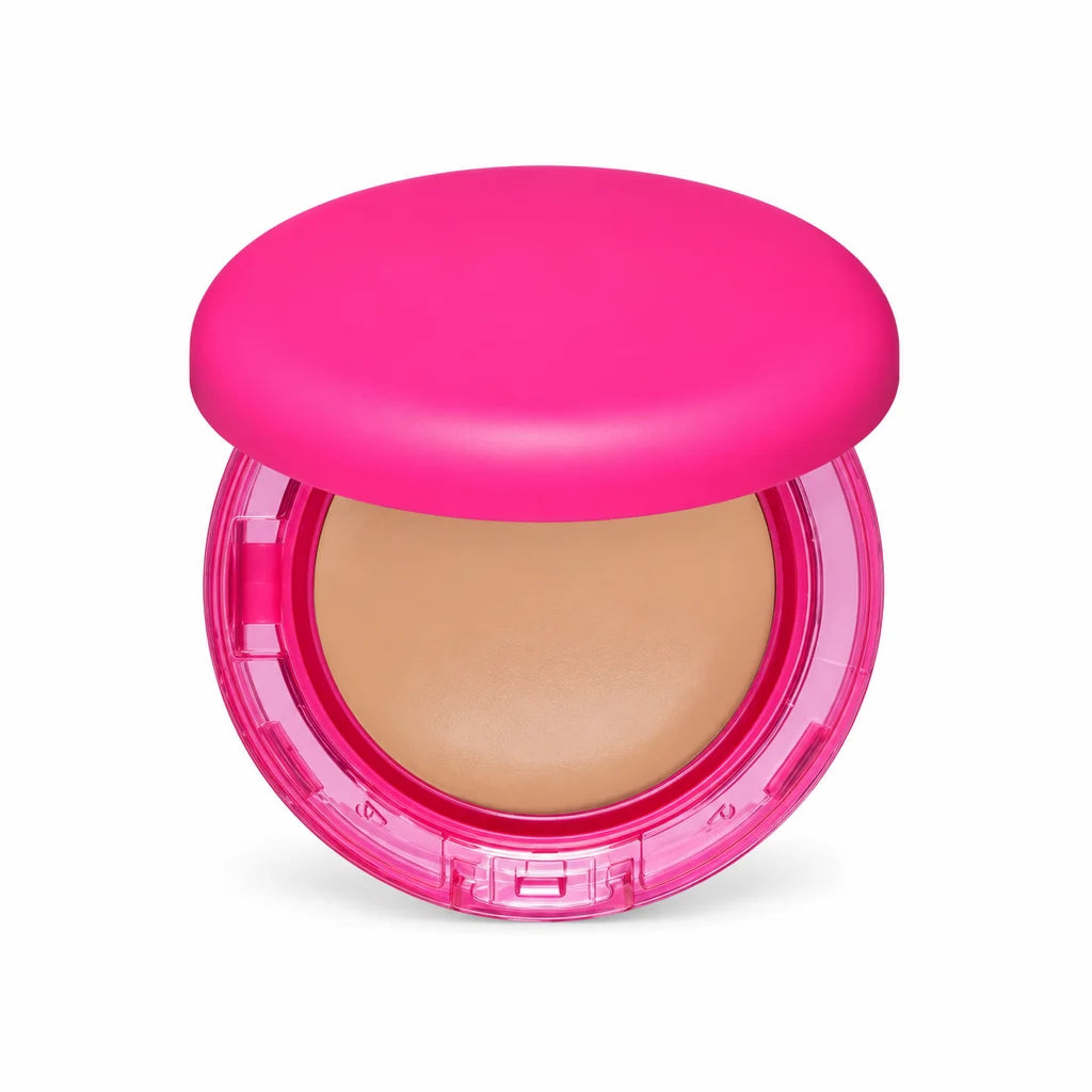 Front view of the pink foundation compact showing its rounded lid, beige pan, transparent rim and clasp on a white background