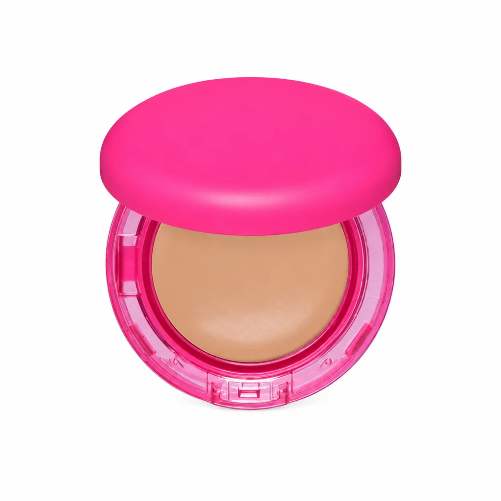 Single pink foundation compact shown from the front on white, with a beige pan, clear rim, round lid and clasp fully visible.