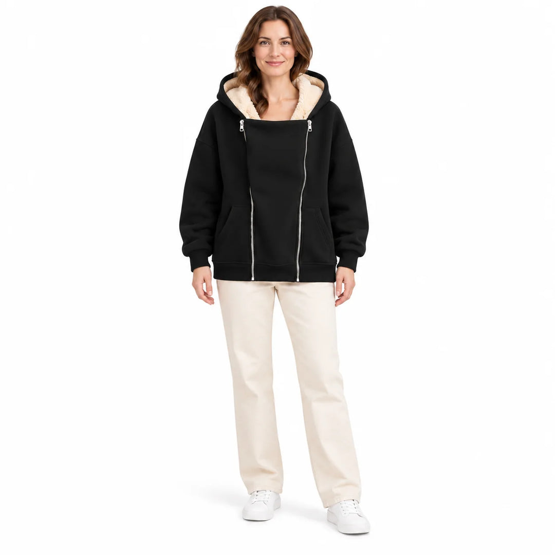 Heavyweight zip up hoodie in Black on a full-body female model, with cream hood lining, twin front zippers and front pockets.