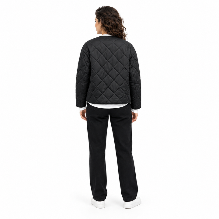Back view of Black diamond-quilted jacket on a full-body model