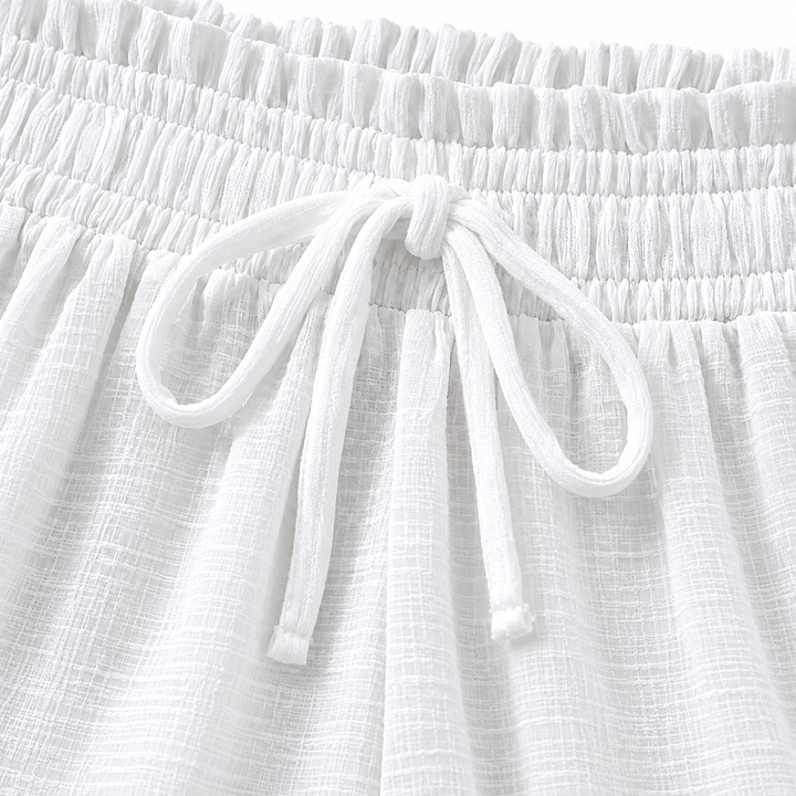 Close-up of the White trousers elastic waistband and tied drawstring