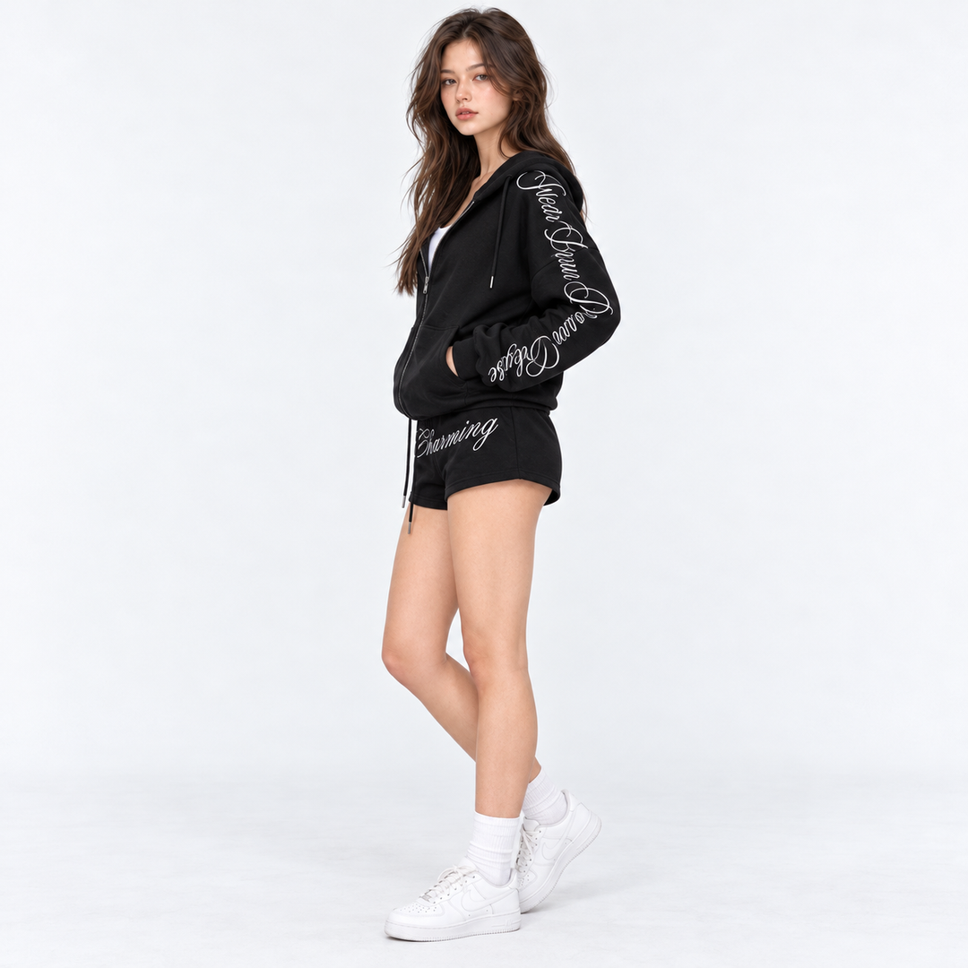 Black hoodie and shorts photographed in side profile on model