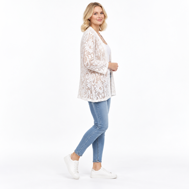 White cardigan on a model, shown from the side against a white background. The floral lace is shown in the photographed view.