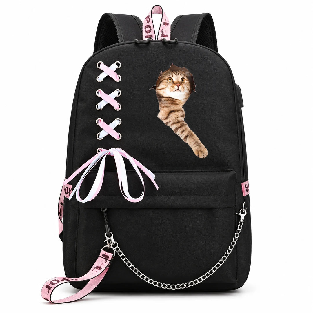 Black backpack with a reaching tabby cat print on the front, pink-and-white ribbon lacing, a bow and a silver chain on white.