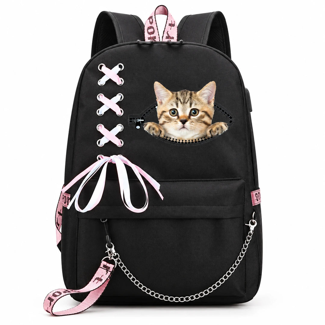 Black backpack with a tabby kitten peeking above a printed zipper, pink-and-white ribbon lacing and bow, with a silver chain.