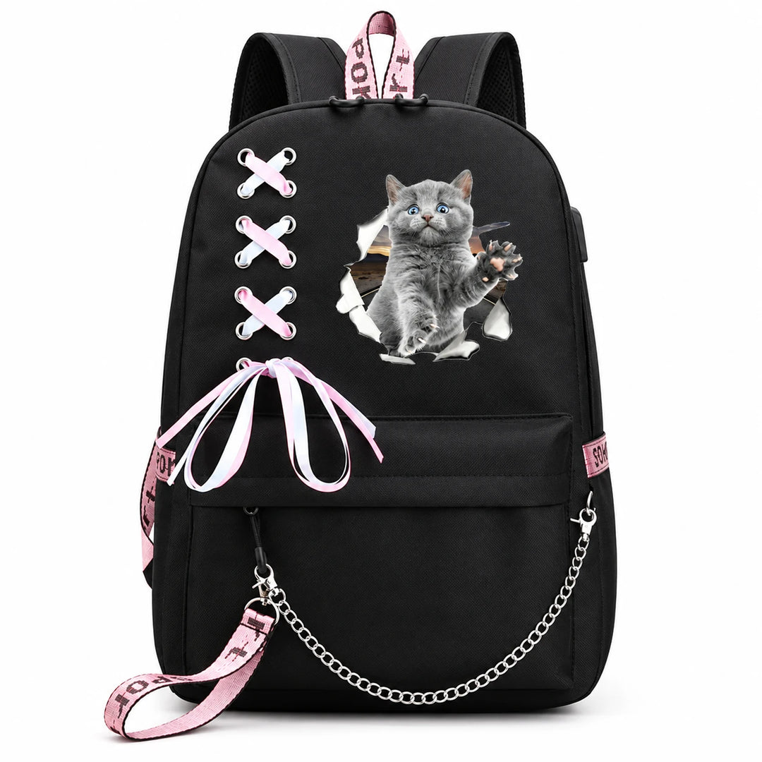 Black bag with a grey kitten raising one paw through a torn-paper print, pink-and-white bow and draped silver chain on white.