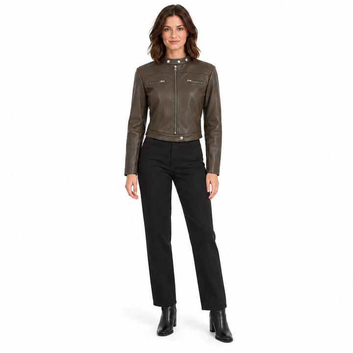 Cropped faux leather jacket in Coffee worn by a brunette model with black trousers and ankle boots in a white studio setting.
