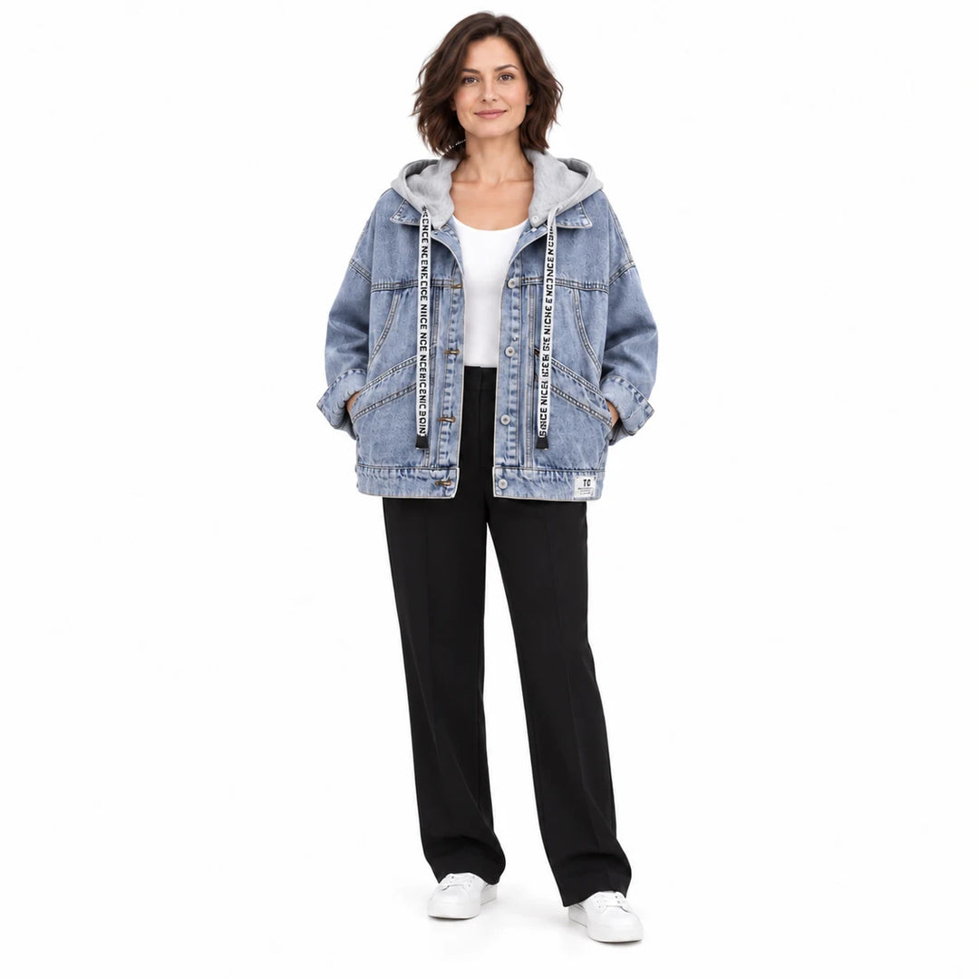 Second adult model wearing the washed blue jacket with grey hood, curved pockets and long sleeves, in a full body studio view