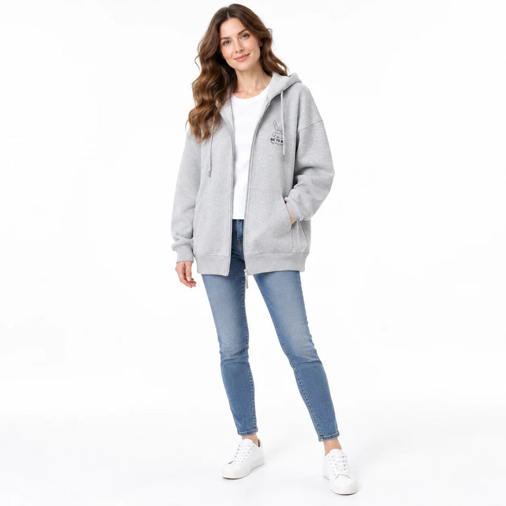 Gray rabbit motif zip hoodie worn by an adult woman, showing the hood, zipper and front pockets, on a plain white background.