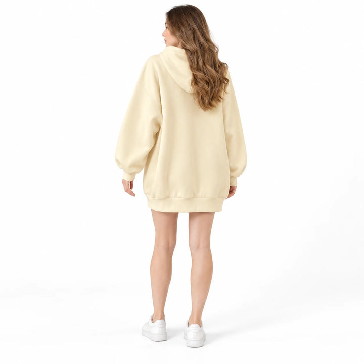 Apricot Yellow rabbit zip hoodie shown on a woman facing away, showing the plain back and hood, on a white studio background.
