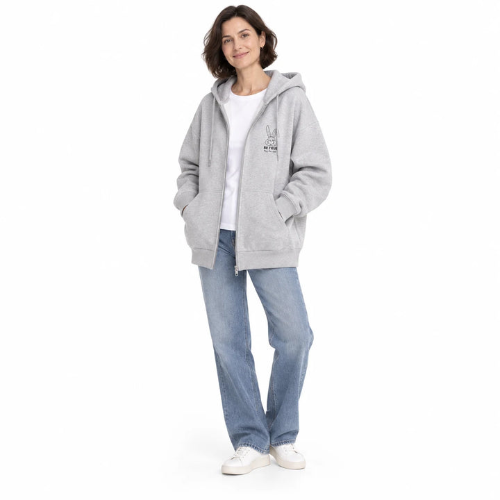 Gray rabbit motif zip hoodie worn by an adult woman, showing the hood, zipper and front pockets, on a plain white background.