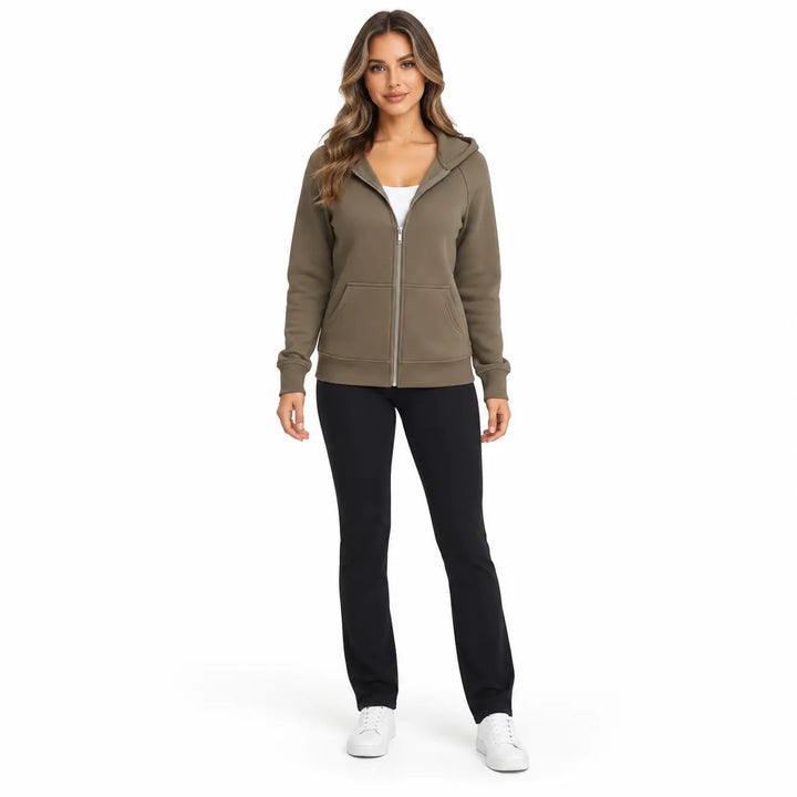 Studio model wearing the Olive Taupe zip hoodie, showing a front zipper, hood and ribbed cuffs, on white with black trousers.