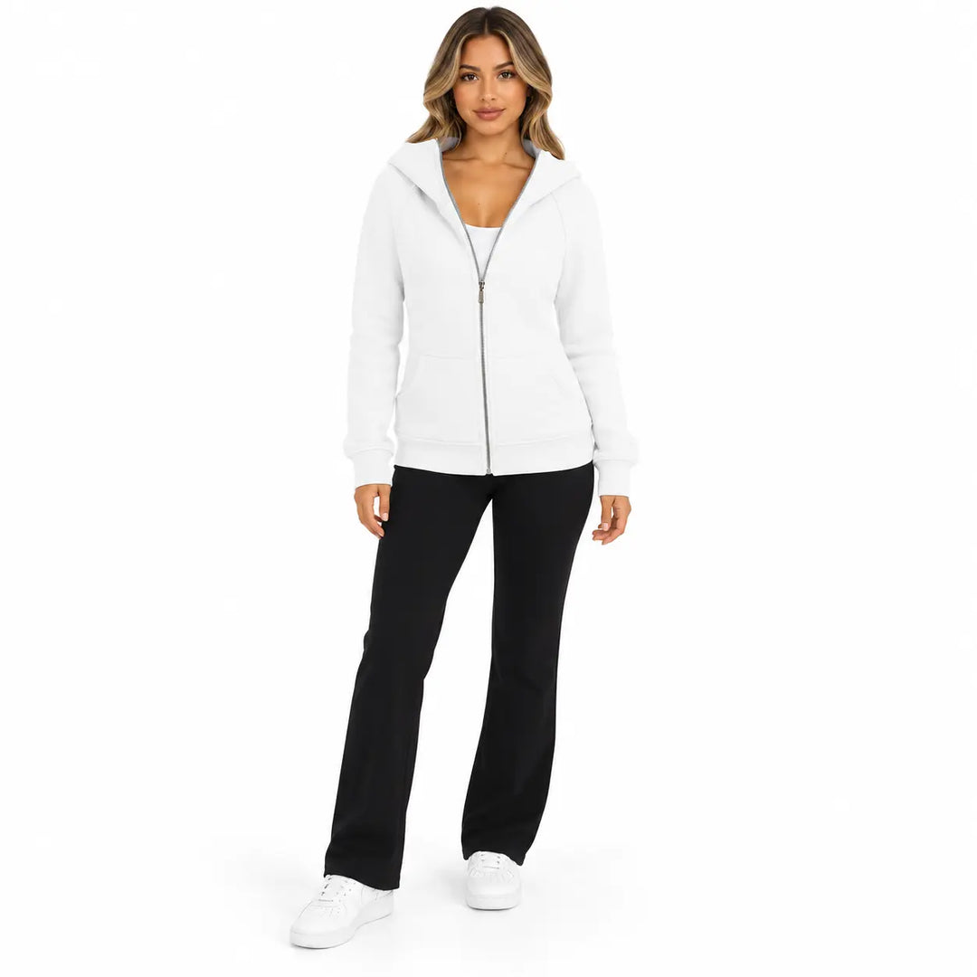 Full-body model wearing the White zip hoodie, showing front pockets, ribbed cuffs and hem, against a white studio background.