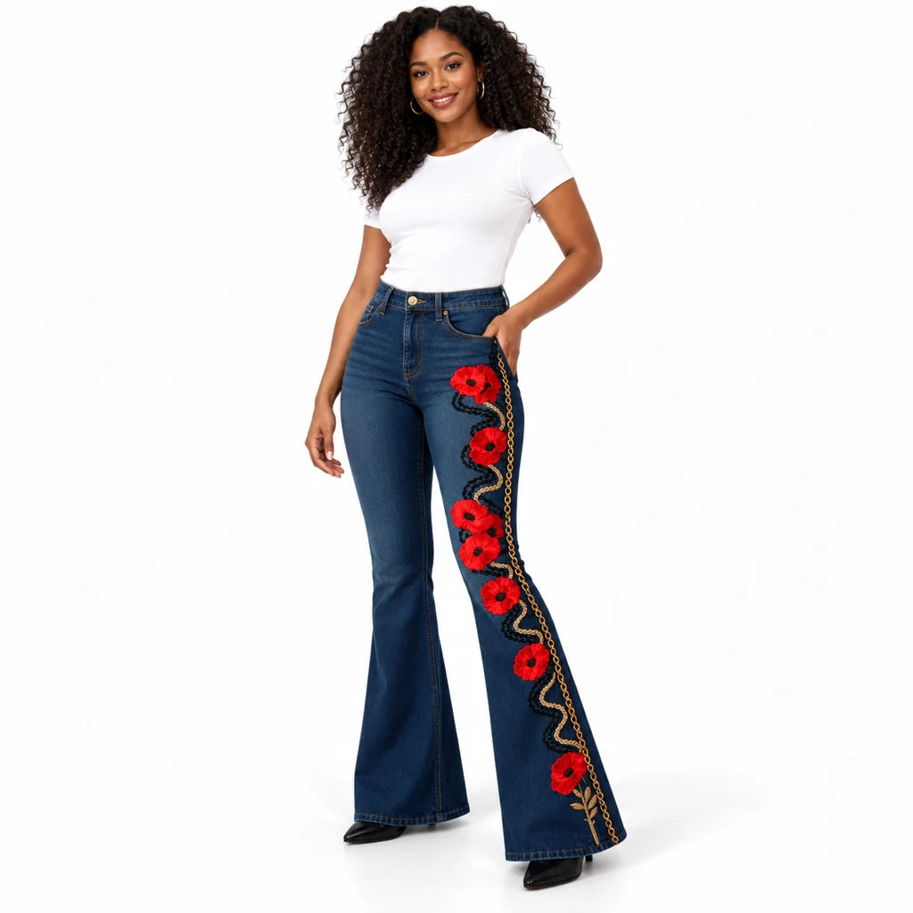 Three-quarter front view of a model in dark blue flared jeans with red poppies and black and gold-tone vine print.