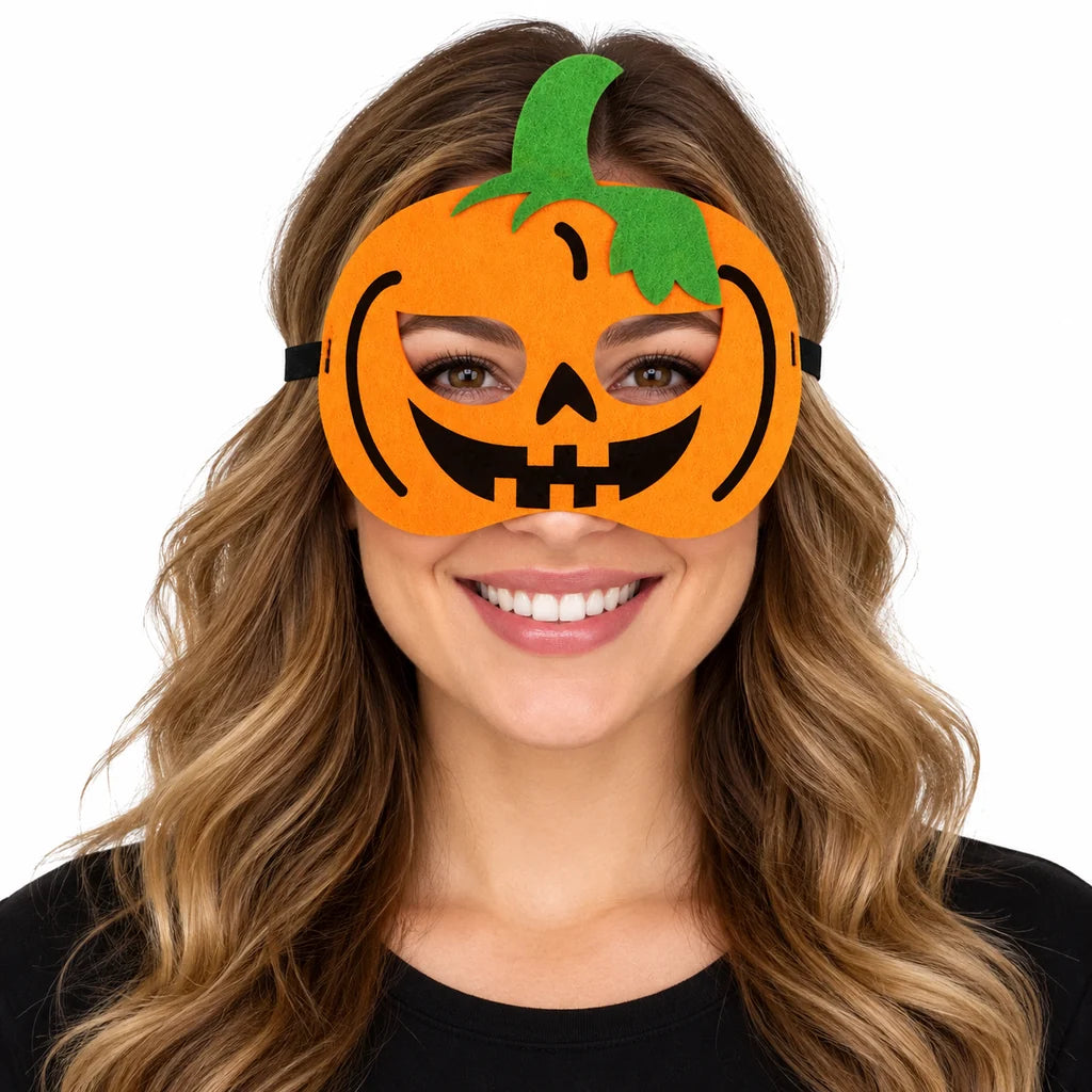 Adult woman wearing an orange pumpkin Halloween eye mask with black smile and green stalk, photographed on a white background