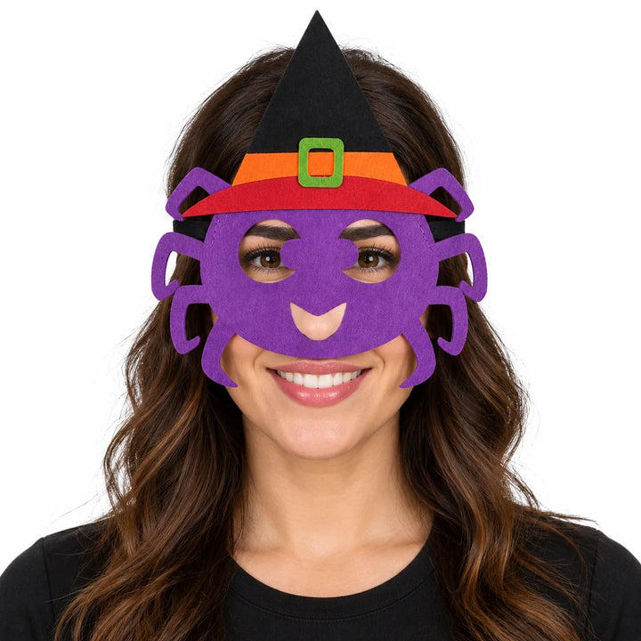 Adult woman wearing a purple spider felt mask with black pointed hat, orange band and green buckle against a white background