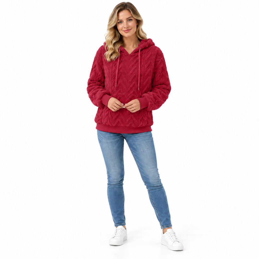 Red hooded sweatshirt on a blonde model, shown full length on a white background. This textured fabric is shown in this view.