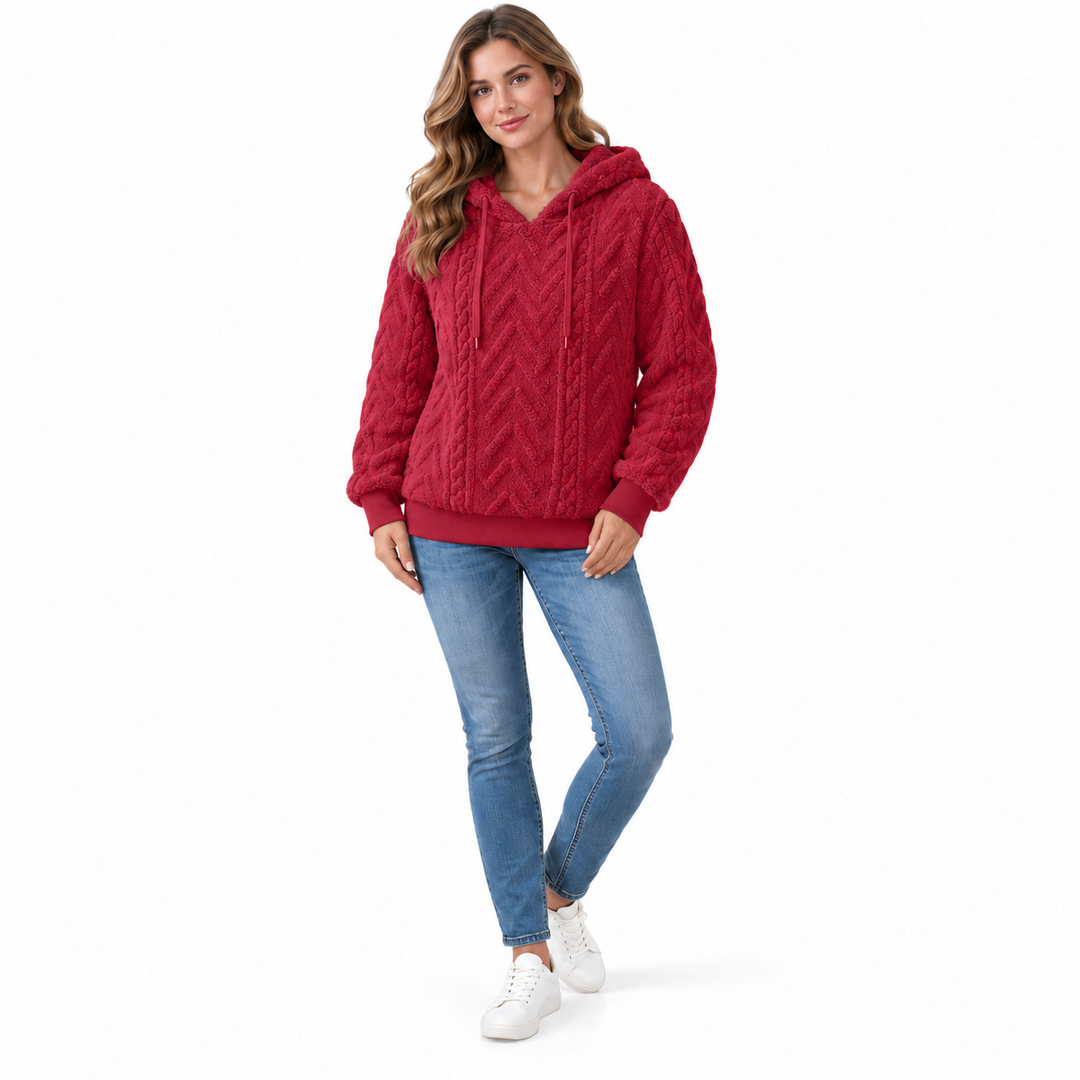 Red textured hoodie on a model, shown at an angle on a white background. The textured fabric appears in the pictured garment.