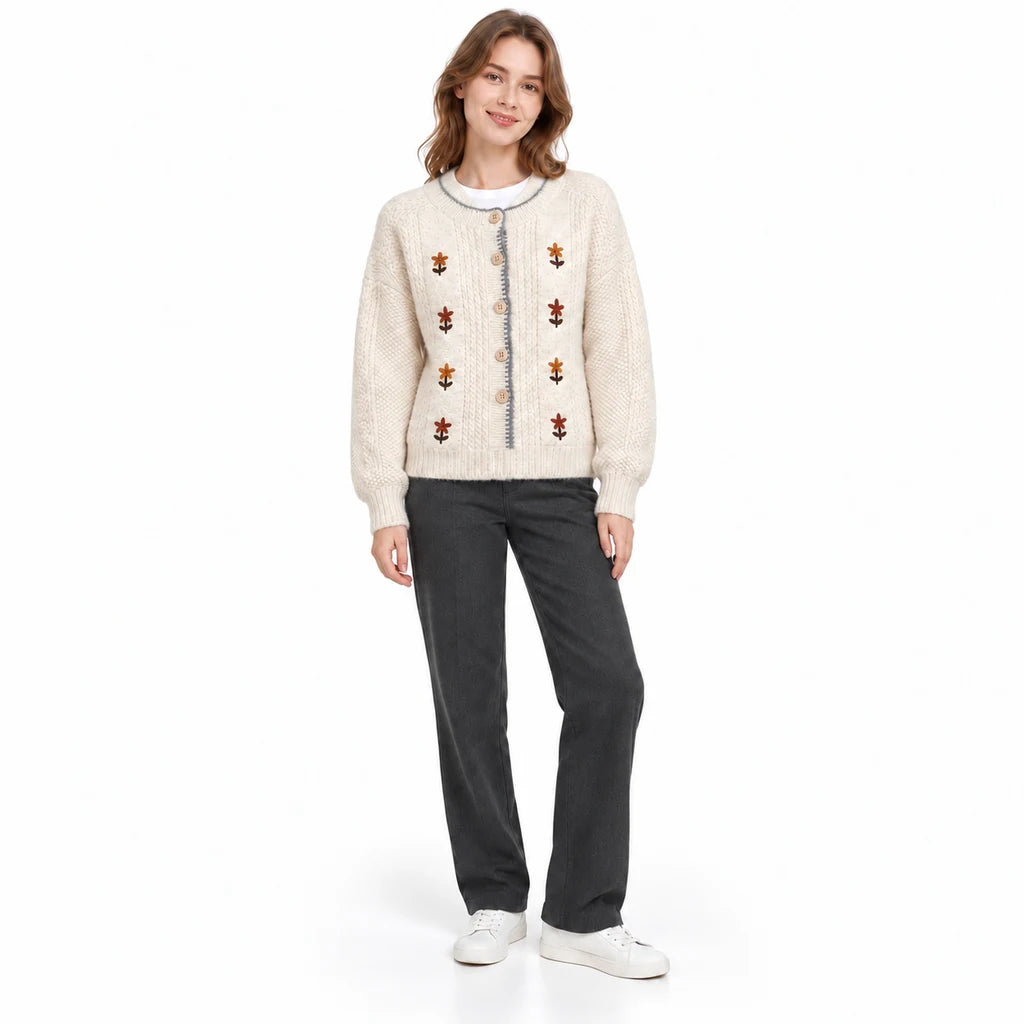 Embroidered cardigan shown in a front-facing pose, with ivory knit, rust floral motifs and beige buttons on white background.