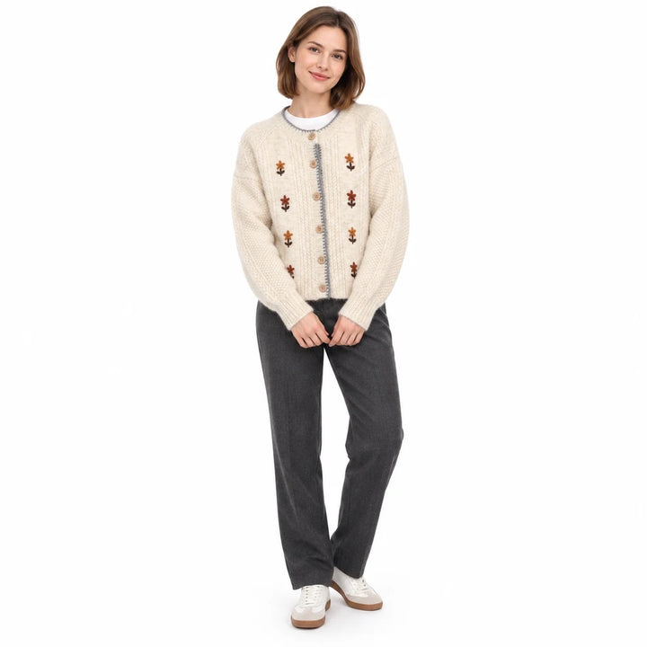 Ivory Floral cardigan sold variant viewed on a full-length model, with a button front, round neck and long sleeves in studio.