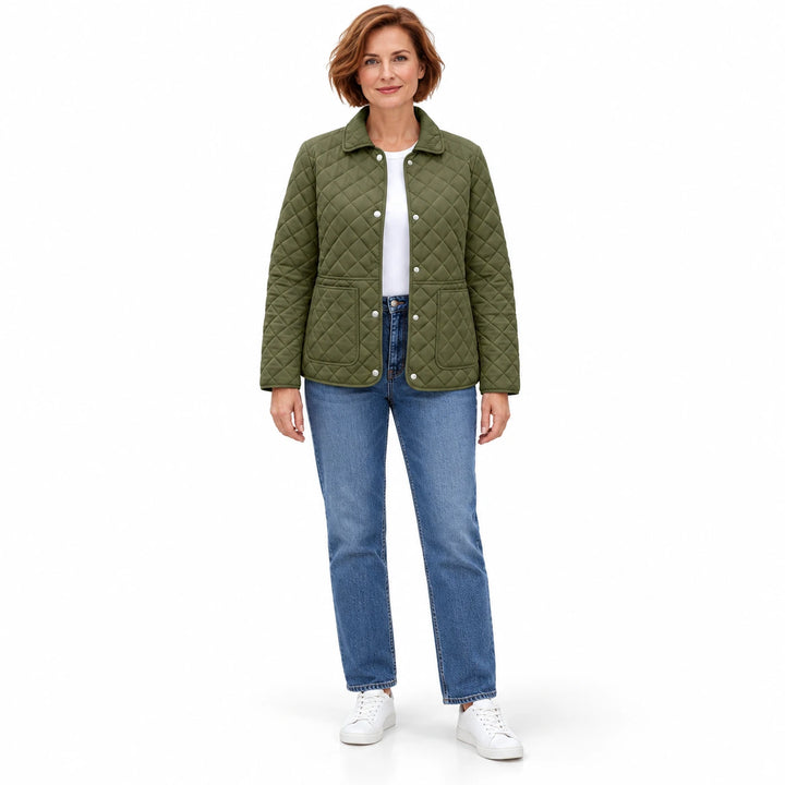 Army Green quilted jacket on an adult model with an auburn bob, blue jeans and white sneakers, shown at full length on white.