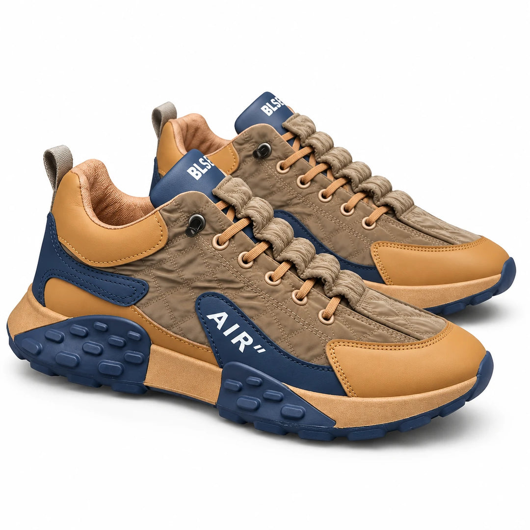 Brown and Navy sneakers in a three-quarter side view showing the lace-up front, layered side panels and rounded outsole pods.